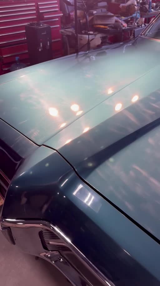 Green Pontiac Grand Prix: paint inspection